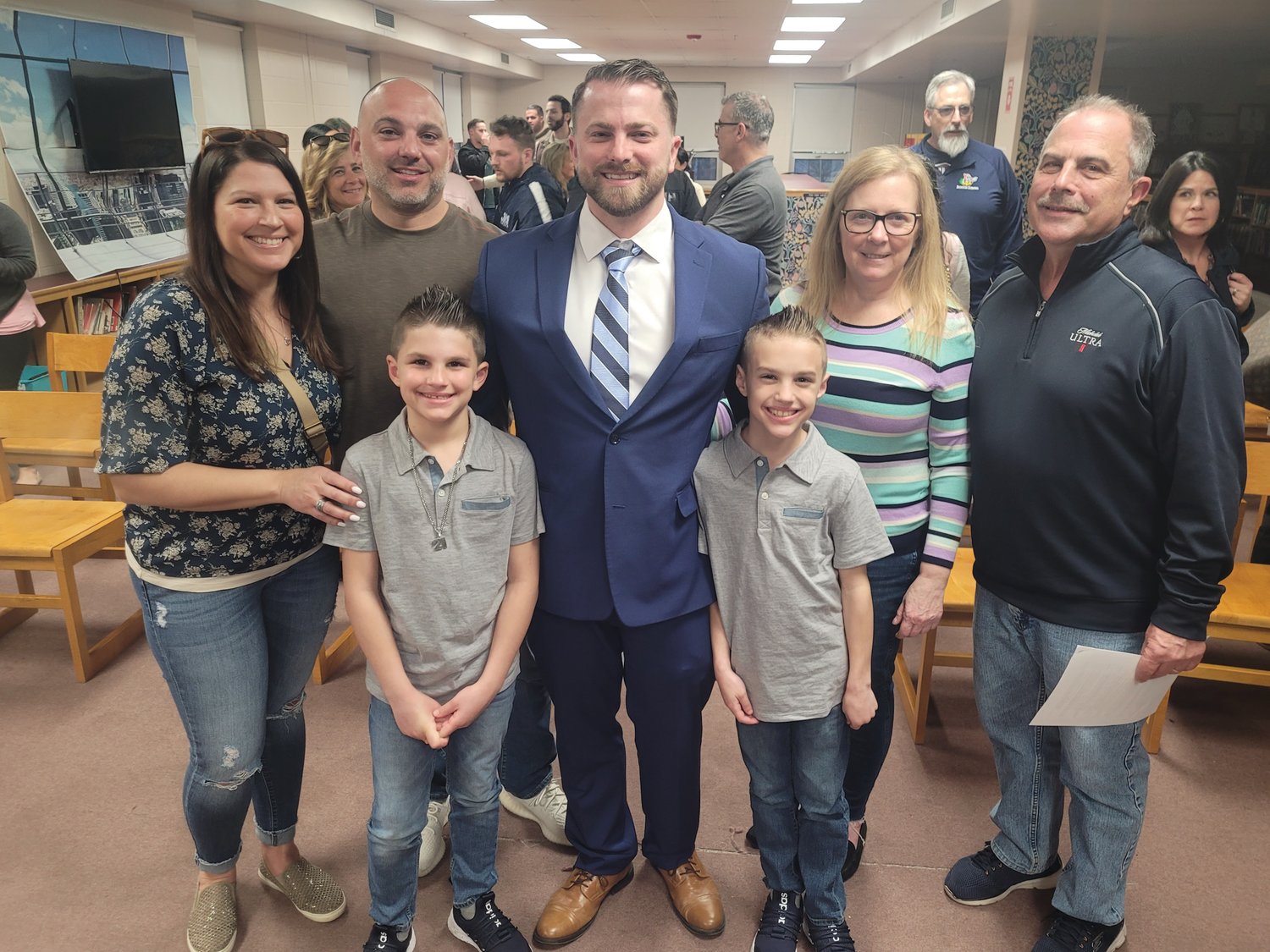 FAMILY SUPPORT: Matt Velino, center, is surrounded by his family after Tuesday night’s Johnston School Committee meeting, where he was officially named new JHS principal. From left to right: Stacy Andreozzi, Dave Andreozzi, Luca Andreozzi (a Brown Avenue Elementary student), Matt Velino, Mason Andreozzi (also a Brown Ave. student), Lori Velino and Paul Velino.